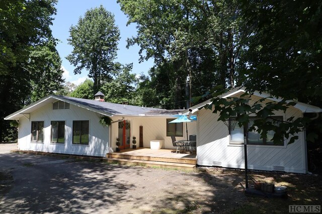 back of property with a wooden deck