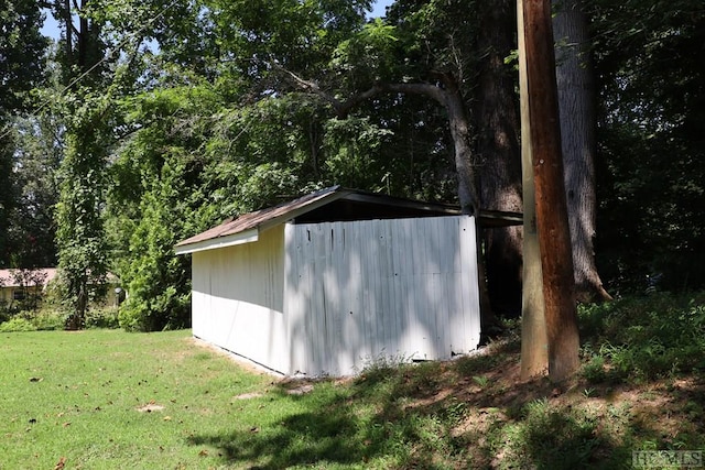 view of outbuilding featuring a lawn