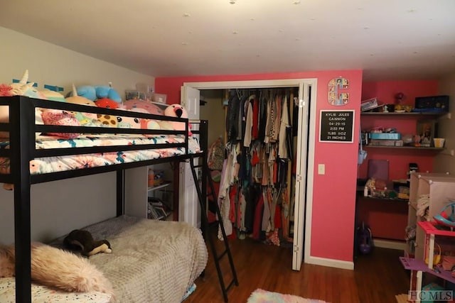 bedroom with a closet and hardwood / wood-style floors