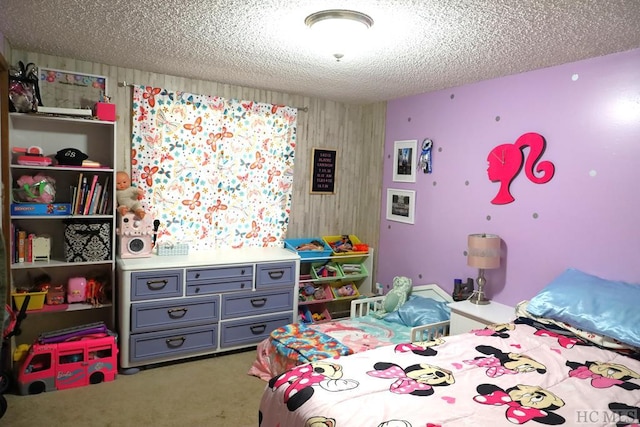 bedroom with carpet floors and a textured ceiling