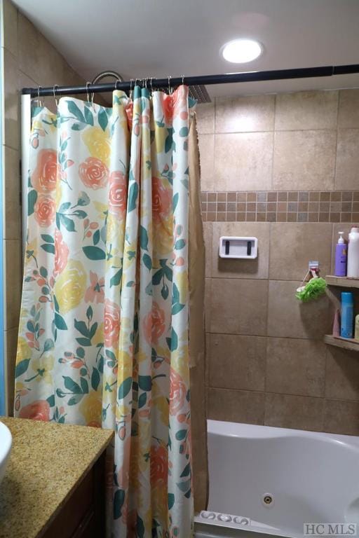 bathroom featuring vanity and shower / bathtub combination with curtain