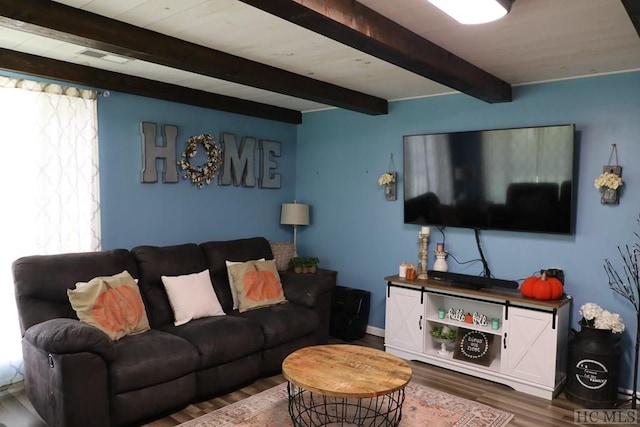 living room with dark hardwood / wood-style flooring and beamed ceiling