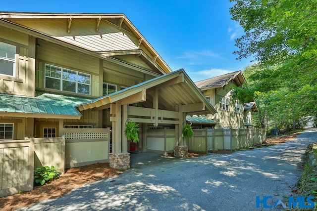 view of home's exterior featuring metal roof and a fenced front yard