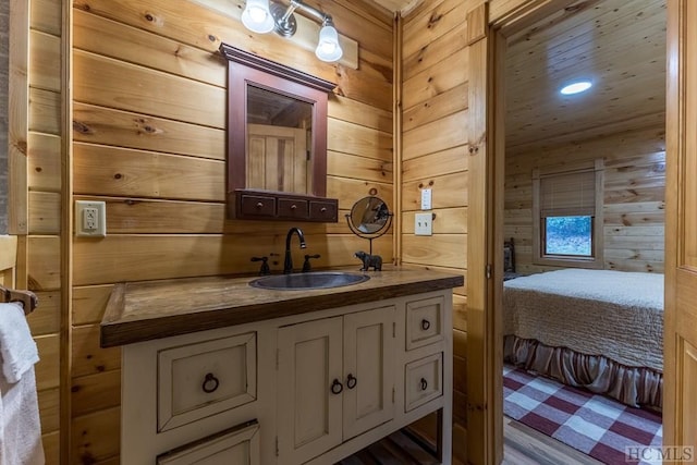 bathroom with vanity and wood walls