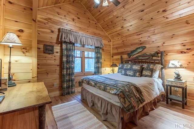 bedroom with wooden walls, lofted ceiling, ceiling fan, wood ceiling, and light wood-type flooring