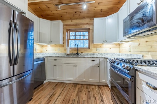 kitchen with sink, light stone counters, wooden ceiling, stainless steel appliances, and white cabinets