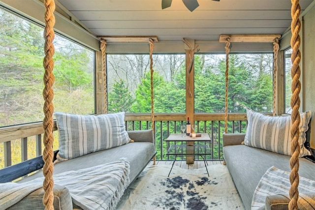 sunroom / solarium featuring outdoor lounge area, a ceiling fan, and a wealth of natural light