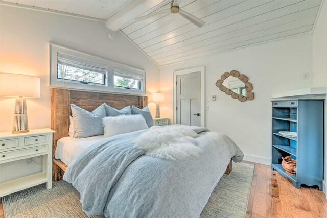 bedroom with wooden ceiling, vaulted ceiling with beams, and light wood finished floors