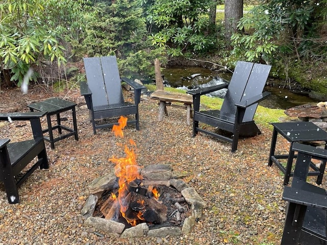 surrounding community featuring an outdoor fire pit