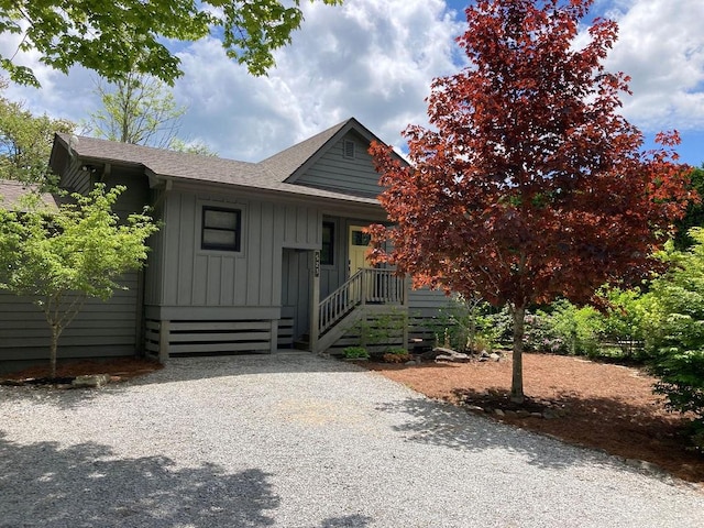 view of front of home with board and batten siding and roof with shingles