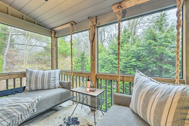 sunroom / solarium featuring a forest view