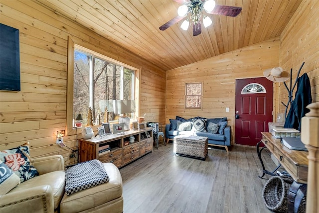 living room featuring wood walls, wood ceiling, vaulted ceiling, hardwood / wood-style flooring, and ceiling fan