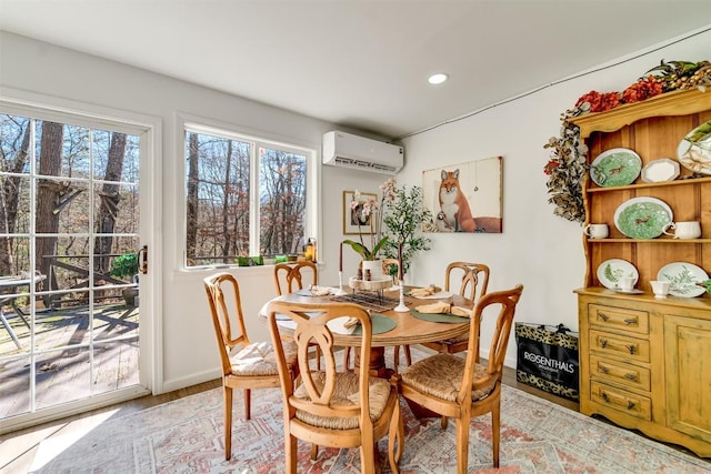 dining space featuring light hardwood / wood-style flooring and a wall mounted AC