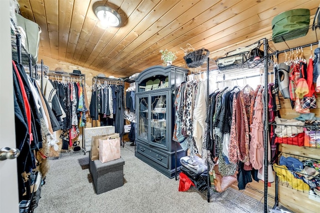 walk in closet featuring lofted ceiling and carpet