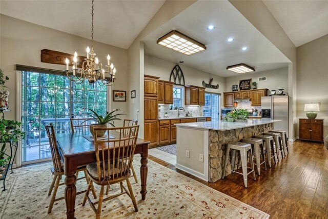 236 Hemlock Woods Dr, Highlands, NC 28741 - dining area featuring vaulted ceiling, healthy amount of natural light, a chandelier, light wood-style floors, and recessed lighting