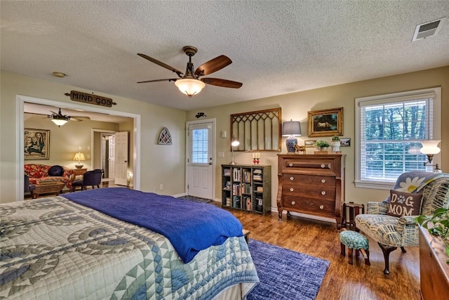 236 Hemlock Woods Dr, Highlands, NC 28741 - bedroom with a textured ceiling, wood finished floors, and ceiling fan