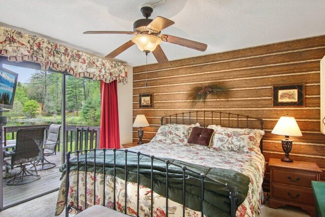 383 Wild Game Trl Unit D, Sapphire, NC 28774 - bedroom featuring access to outside, ceiling fan, a textured ceiling, and wood finished floors