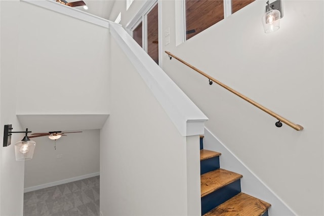 stairway featuring carpet, ceiling fan, and baseboards