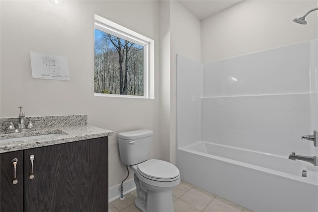 bathroom with toilet, tile patterned floors, vanity, shower / washtub combination, and baseboards