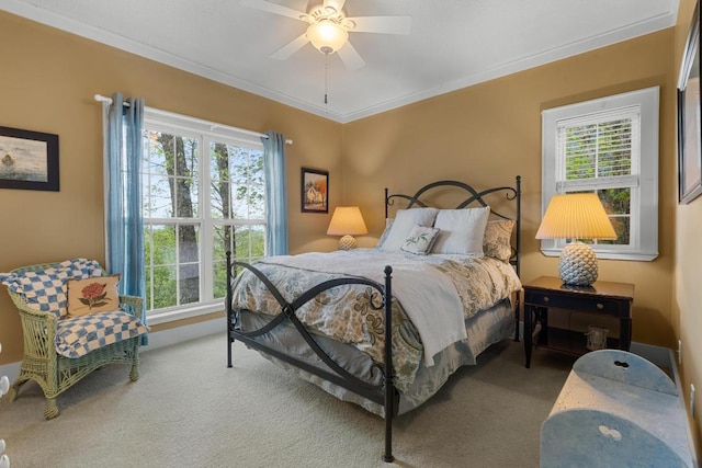 bedroom with multiple windows, carpet flooring, crown molding, and a ceiling fan