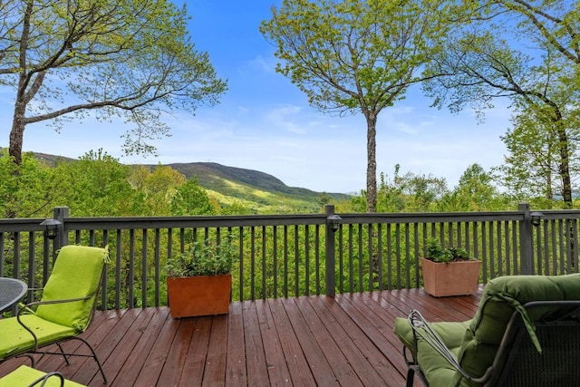 wooden deck with a mountain view
