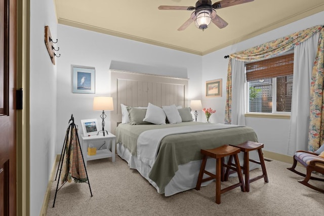 bedroom featuring light colored carpet, baseboards, and ceiling fan