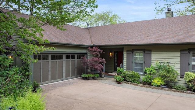 ranch-style home with driveway, a garage, roof with shingles, and a chimney
