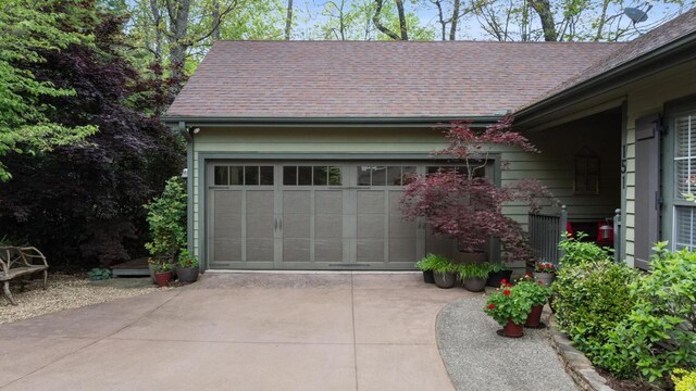 garage featuring concrete driveway