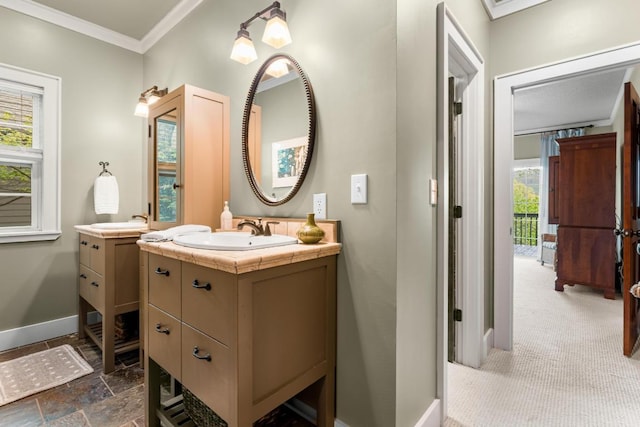 bathroom with two vanities, baseboards, and ornamental molding
