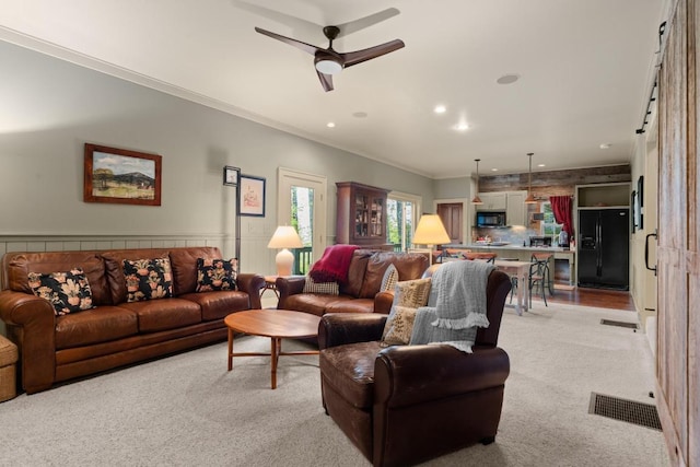 living room featuring ceiling fan, light carpet, crown molding, and recessed lighting