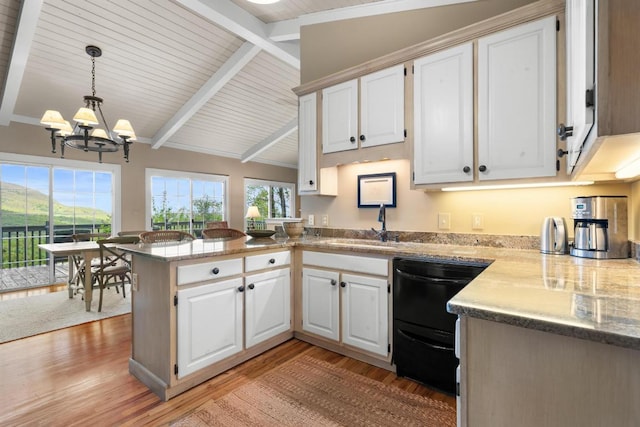 kitchen with a chandelier, dishwasher, a peninsula, and light wood-style flooring