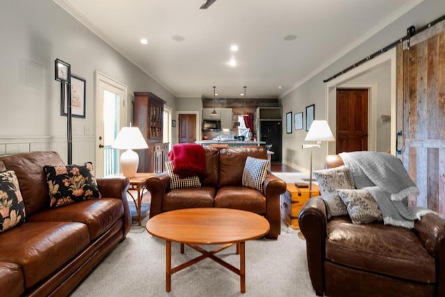 living room featuring ornamental molding, a barn door, and recessed lighting
