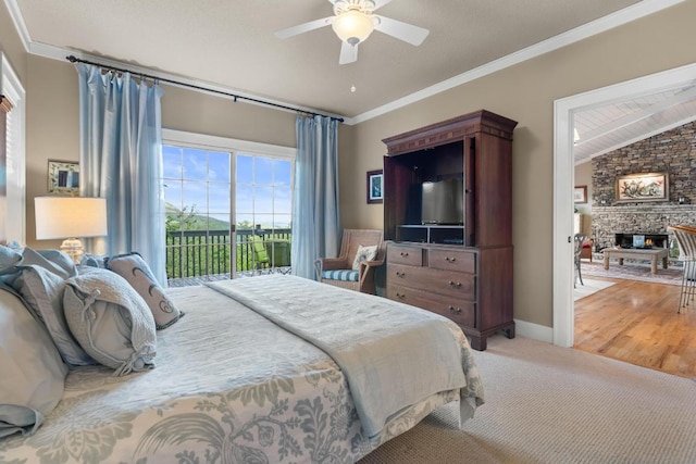 bedroom featuring access to outside, a stone fireplace, ornamental molding, light colored carpet, and ceiling fan