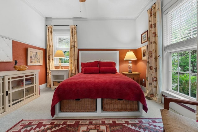 bedroom with carpet flooring, multiple windows, and crown molding