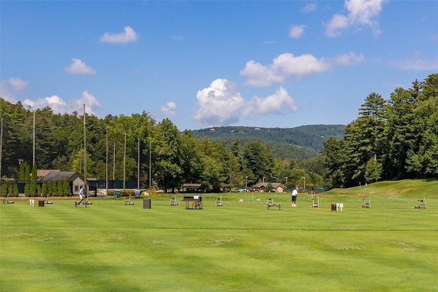 view of home's community featuring a lawn and golf course view