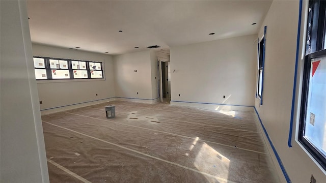 empty room featuring baseboards and visible vents