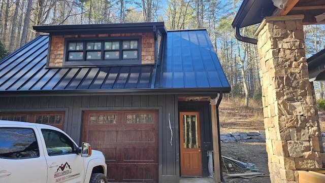 exterior space with a garage, metal roof, and a standing seam roof