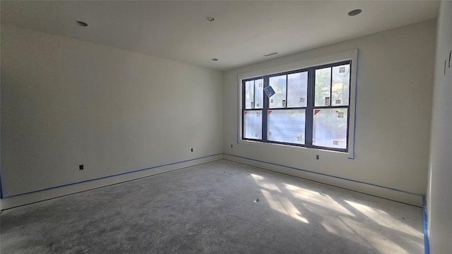spare room with recessed lighting and concrete floors
