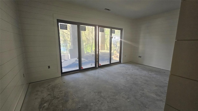 spare room with concrete floors and visible vents