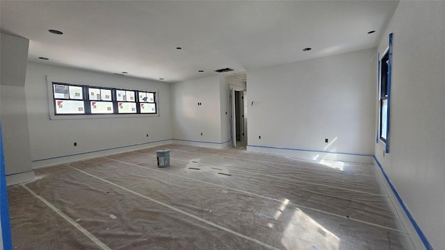 spare room featuring baseboards and visible vents