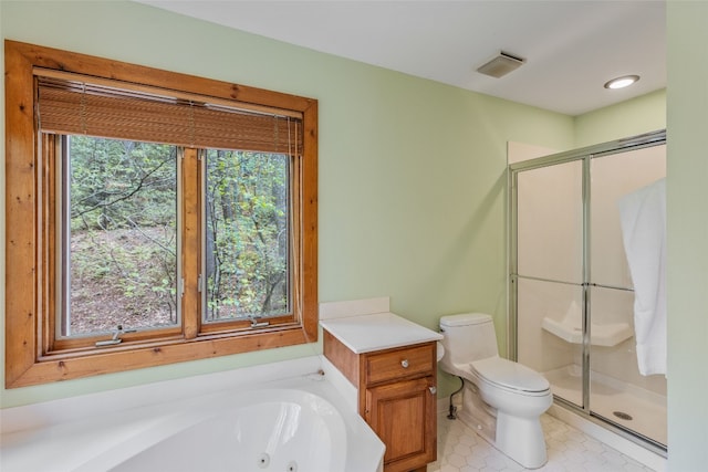 bathroom with tile patterned flooring, a tub with jets, a shower stall, and toilet