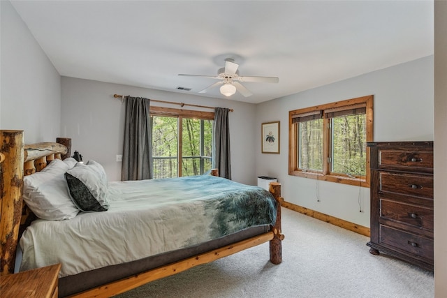 bedroom featuring baseboards, a ceiling fan, carpet flooring, and visible vents