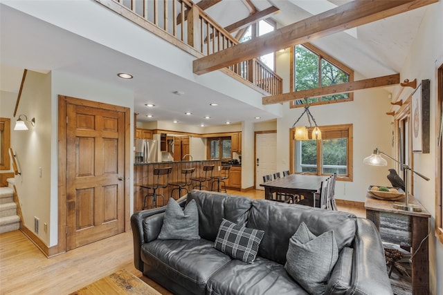 living room with baseboards, high vaulted ceiling, stairway, recessed lighting, and light wood-style flooring