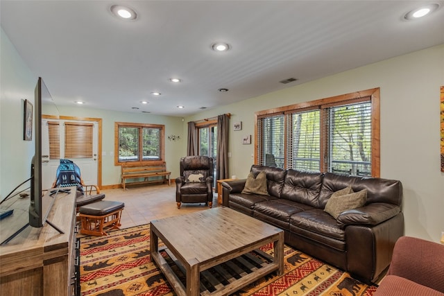 living area with baseboards, recessed lighting, and visible vents
