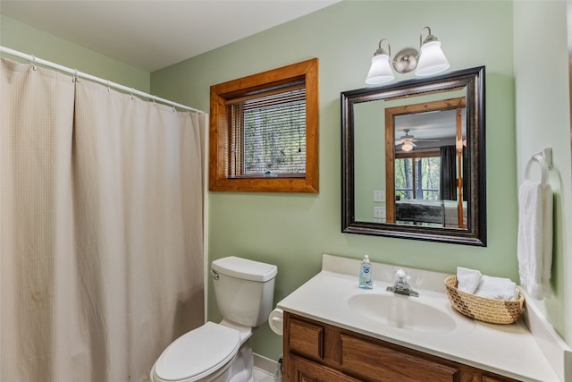 full bathroom featuring toilet, baseboards, and vanity