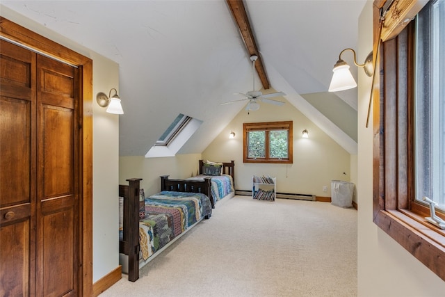 bedroom featuring vaulted ceiling with skylight, ceiling fan, baseboard heating, a baseboard heating unit, and carpet flooring