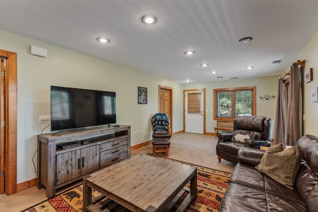 living room with recessed lighting, baseboards, and light tile patterned flooring