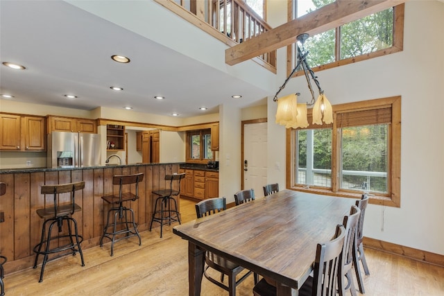dining room featuring recessed lighting, baseboards, and light wood finished floors