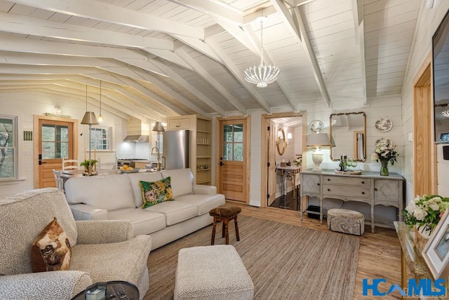 living room with lofted ceiling with beams, wooden ceiling, light wood-style flooring, and a notable chandelier