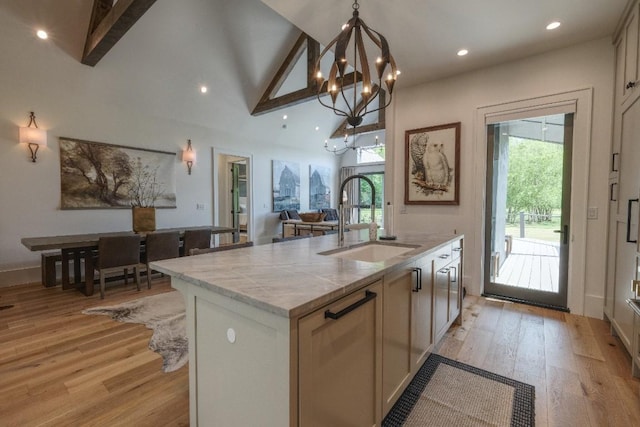 kitchen with a sink, plenty of natural light, light wood-type flooring, recessed lighting, and high vaulted ceiling